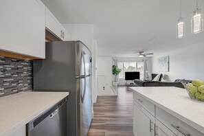 A modern kitchen with a stainless steel refrigerator, a wooden backsplash, and a countertop. - Spacious Vegas Retreat • Close to Strip • Sleep 12 (Las Vegas)