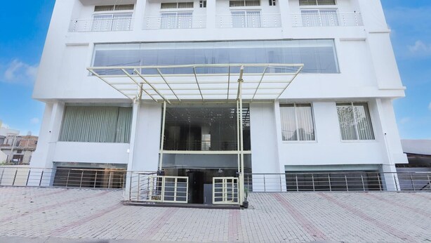 A modern two-story building with a covered entrance and a balcony. - Townhouse Tender Village Seven Seas (Ranchi)