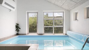 An indoor swimming pool with a view of greenery through large windows. - VillaVilla 974 - Hvide Sande, Vestjylland (Hvide Sande)