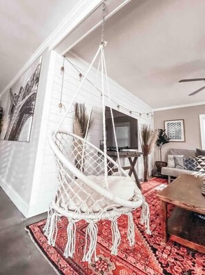 A room with a hanging chair, a television, and a sofa. - White Bohemian,2 houses, 9000 sq ft Games, Hot Tub Events - sleeps 34 (Atlanta)