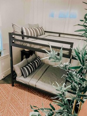 A bunk bed with two levels, each with pillows and a blanket. - White Bohemian,2 houses, 9000 sq ft Games, Hot Tub Events - sleeps 34 (Atlanta)