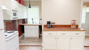 Coffee/tea maker, fridge, microwave, cookware/dishes/utensils