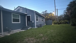 A residential house with a front yard and a garage. - Comfort, Safety, and the Beach (Clearwater)