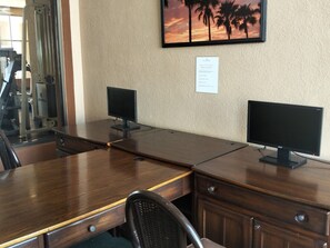 A conference room with two desks, each with a computer monitor, a chair, and a small cabinet. - Sonoran Spa Ground Floor 109-W (Puerto Peñasco)