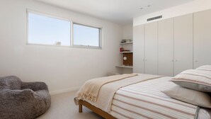 A bedroom with a bed, a chair, a wardrobe, and a window. - Ms Dana Bridgewater - Blairgorwie (Blairgowrie)