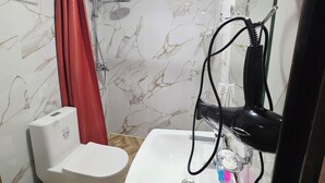 A bathroom with a toilet, sink, shower, and a red curtain. - Samarkand City Center Hotel (Samarkand)