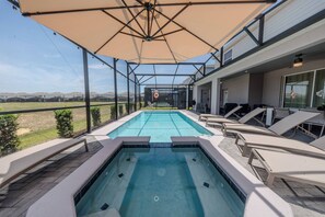 A pool area with a hot tub, lounge chairs, and a covered patio. - Go!#37 - WINDSOR ISLAND (Davenport)