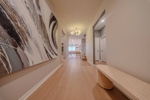 A hallway with a marble wall, wooden flooring, and a bench. - Go!#37 - WINDSOR ISLAND (Davenport)