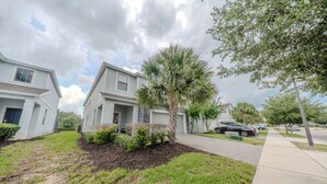 A residential area with houses, a paved driveway, and a sidewalk. - Go!#41 - WINDSOR AT WESTSIDE (Kissimmee)