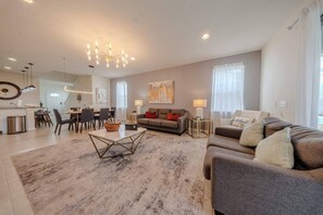 A modern living room with a dining area, a sofa set, and a chandelier. - Go!#41 - WINDSOR AT WESTSIDE (Kissimmee)