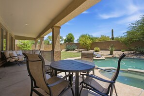 An outdoor patio with a pool, seating area, and a view of the surrounding landscape. - Grayhawk Scottsdale Retreat - Private Pool and Spa (Scottsdale)