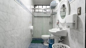 A bathroom with a toilet, sink, and shower area. - Fantastic 6-bedroom resort with AC in sunny San Salvador, Luxury house villa (San Salvador)