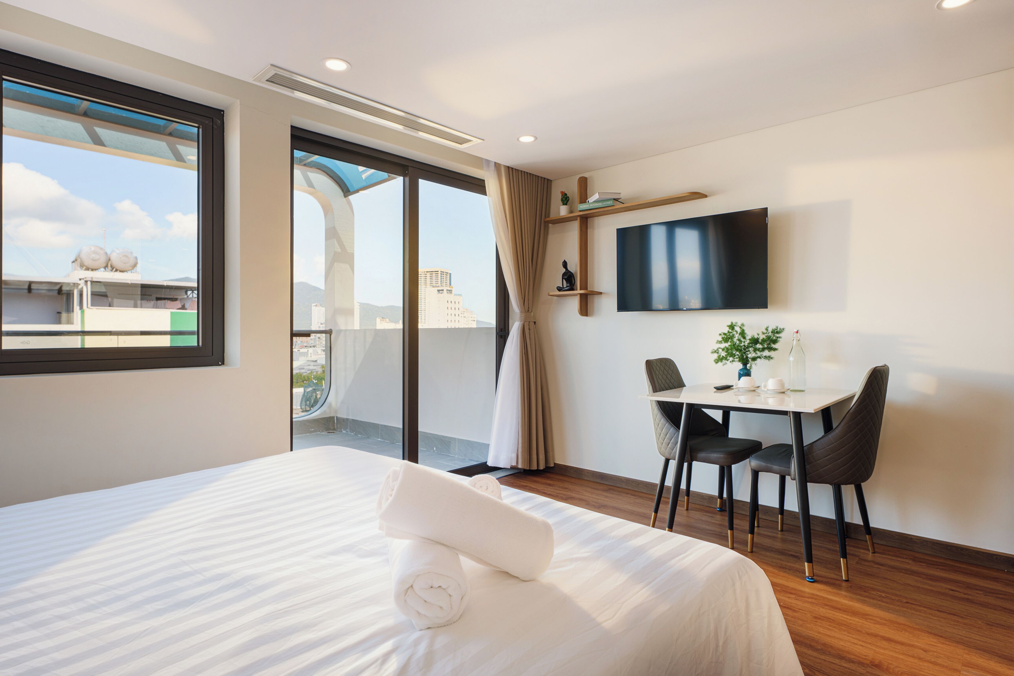 Premium Studio, Balcony, City View | Desk, laptop workspace, blackout curtains