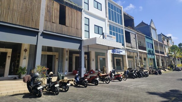 A row of modern buildings with a restaurant named 'Moonrise' on the ground floor. - Moonrise Rooms (Pecatu)