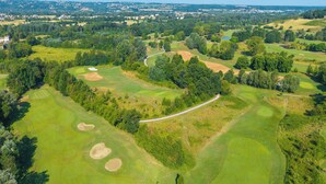 A golf course with multiple bunkers and a winding path.