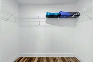 A small, empty closet with white walls and a wooden floor. - Lakefront Lake Anna | Hot Tub, Beach & Game Room (Orange)