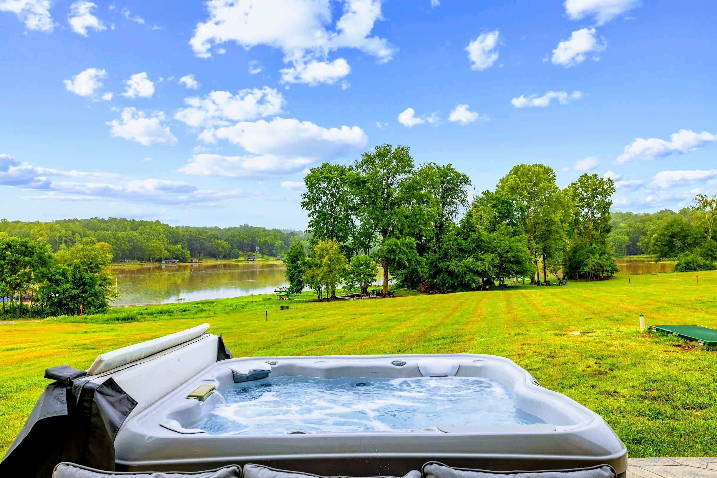 Un jacuzzi con vista a un lago y árboles.