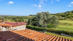 A residential area with a house featuring a red-tiled roof, a staircase, and a view of a green landscape with trees and a golf course. - Villa Carolina Golf View 5, Castelletto d’Orba, Italy (Castelletto d’Orba)