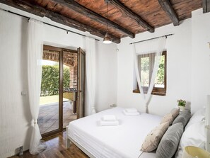 A bedroom with a bed, a window with a view, and a door leading to an outdoor area. - Vacation home Orlene by Interhome (Pula/Vodnjan)