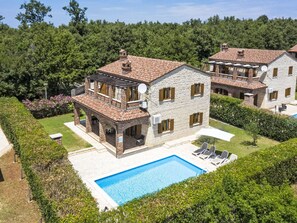 A two-story house with a swimming pool, surrounded by a well-maintained garden and trees. - Vacation home Orlene by Interhome (Pula/Vodnjan)
