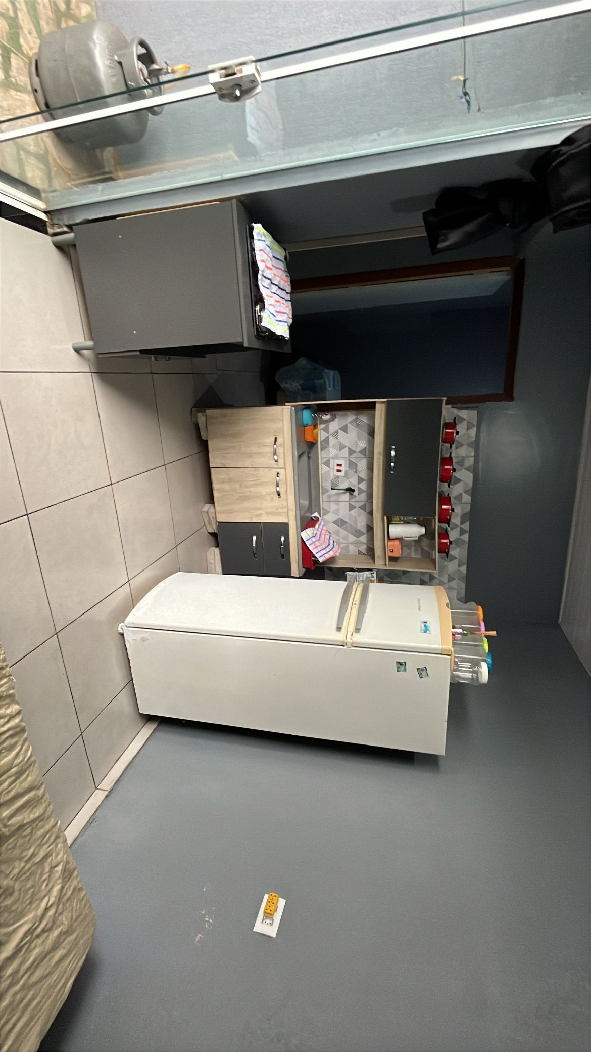 A compact kitchenette with a microwave, a small refrigerator, and a sink.