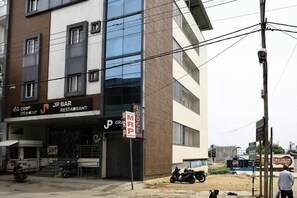 A multi-story building with a restaurant named 'JP Bar Restaurant' on the ground floor.
