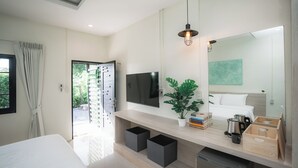 A modern bedroom with a bed, bedside tables, a TV, a mirror, and a view of the outdoors.