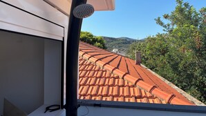 A rooftop with terracotta tiles and a clear view of the surrounding landscape. - Huge Terrace Sea Front (Bosa Marina)