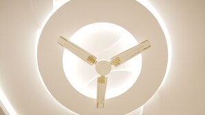 A ceiling fan with three blades and a central light fixture. - VENUS INN ROOMS  AND BANQUETS (Lucknow)