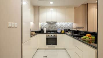 Departamento Deluxe, vista a la ciudad | Cocina privada | Refrigerador con congelador, microondas, horno y parrilla de estufa