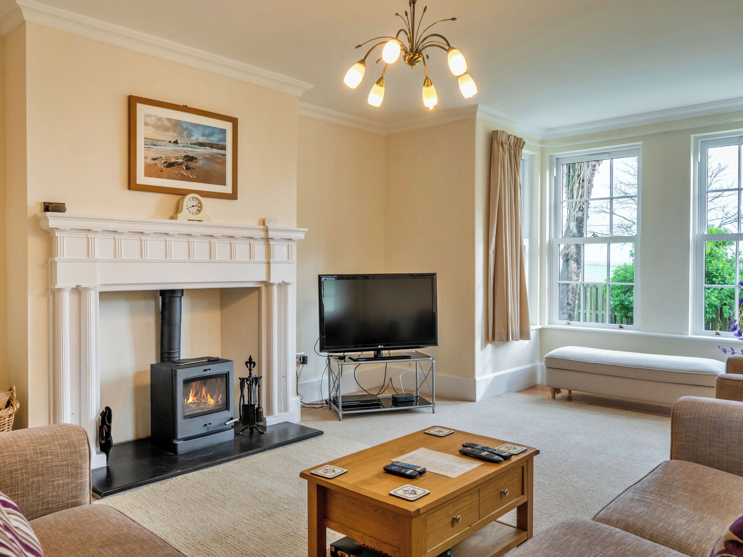 A living room with a fireplace, a television, and a sofa.