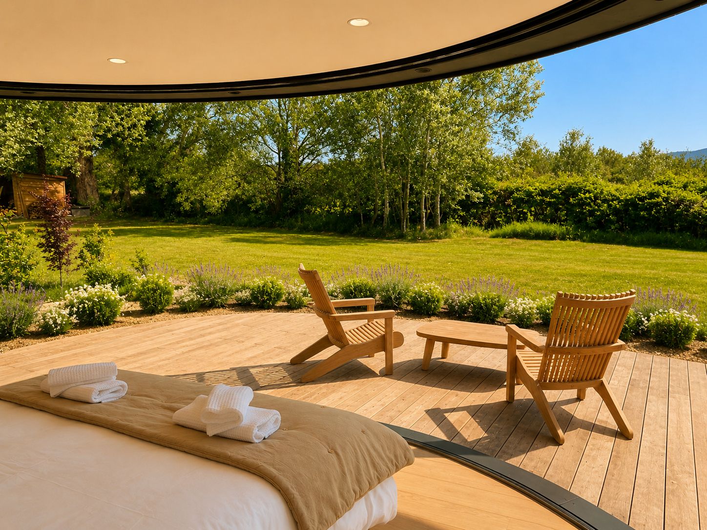 A bedroom with a bed, two wooden chairs, and a view of a lush garden.