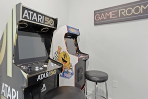 Two Atari 2600 arcade game machines in a room with a sign reading 'GAME ROOM'. - Golf Cart + Community Pool + Game Room | Steps to Beach | Serene on 30A (Santa Rosa Beach)