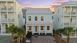 A beachfront property with a two-story building, a covered patio, and a parking area. - Golf Cart + Community Pool + Game Room | Steps to Beach | Serene on 30A (Santa Rosa Beach)
