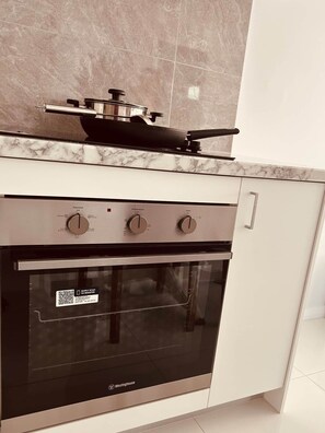 A kitchen with a built-in oven and a stovetop.