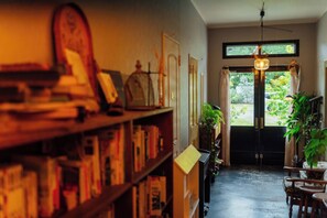 A room with a bookshelf, a desk, a chair, a hanging light fixture, and a view through a door. - A peaceful retreat near the Ise Grand Shrine (isecity setachou)
