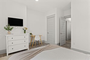 A bedroom with a bed, a dresser, a desk, and a TV. - Golf Cart + Hot Tub + Community Pool | Near the Gulf | 78 Emerald (Santa Rosa Beach)