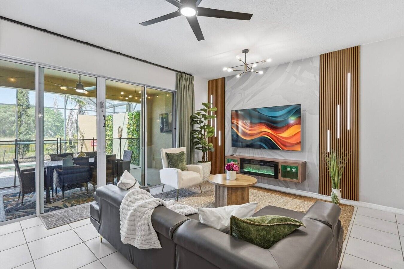 A modern living room with a sofa, a coffee table, and a TV mounted on the wall.