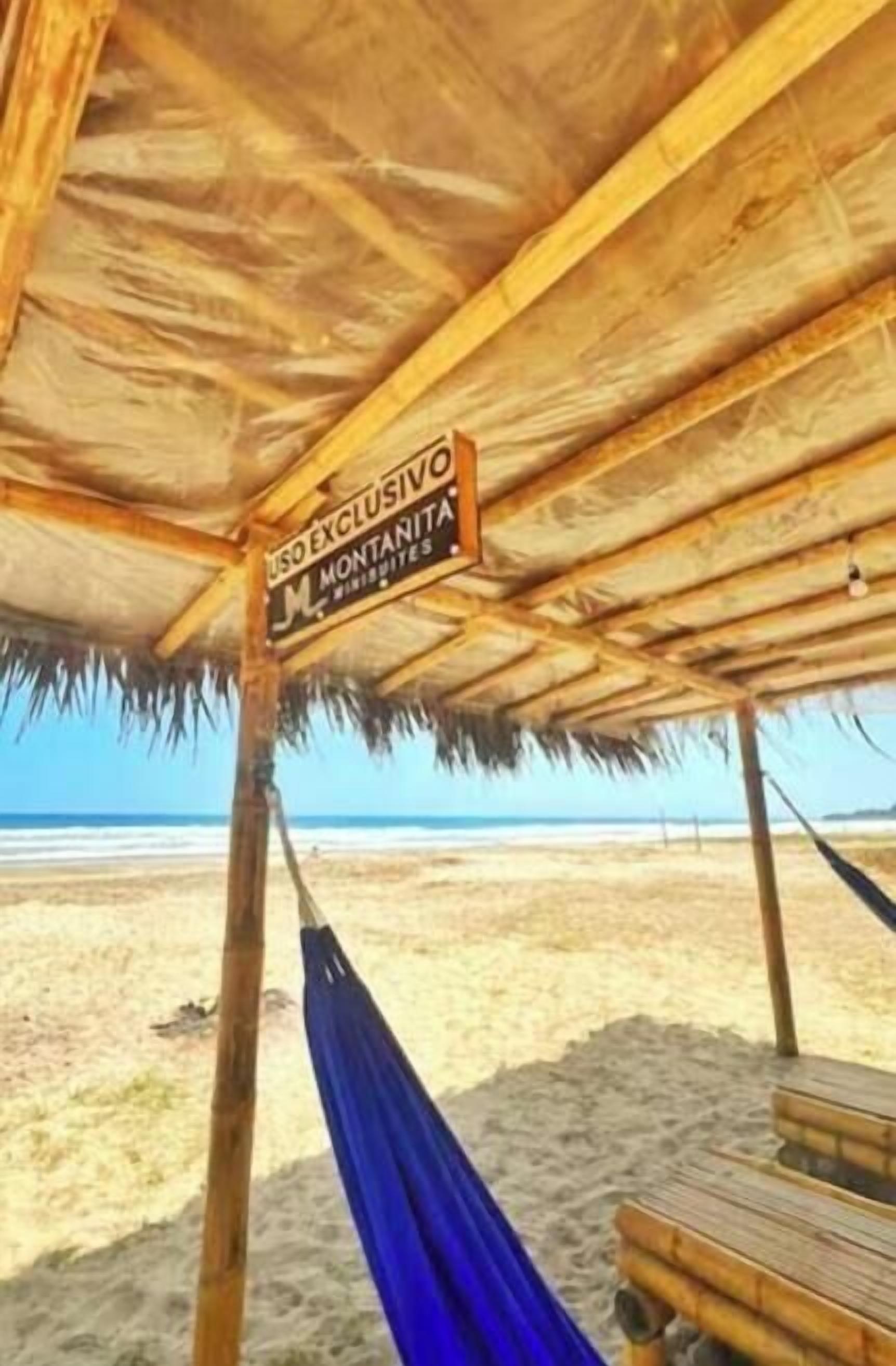 A beach hut with a sign indicating 'EXCLUSIVE MONTANITA BEACHES.'