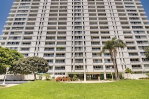 A multi-story hotel with a uniform exterior, featuring balconies and a central entrance.