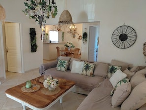 A living room with a sofa, coffee table, and decorative items. - KAZAMIA: Charm & romance—optional hot tub included on weekends (La Motte)