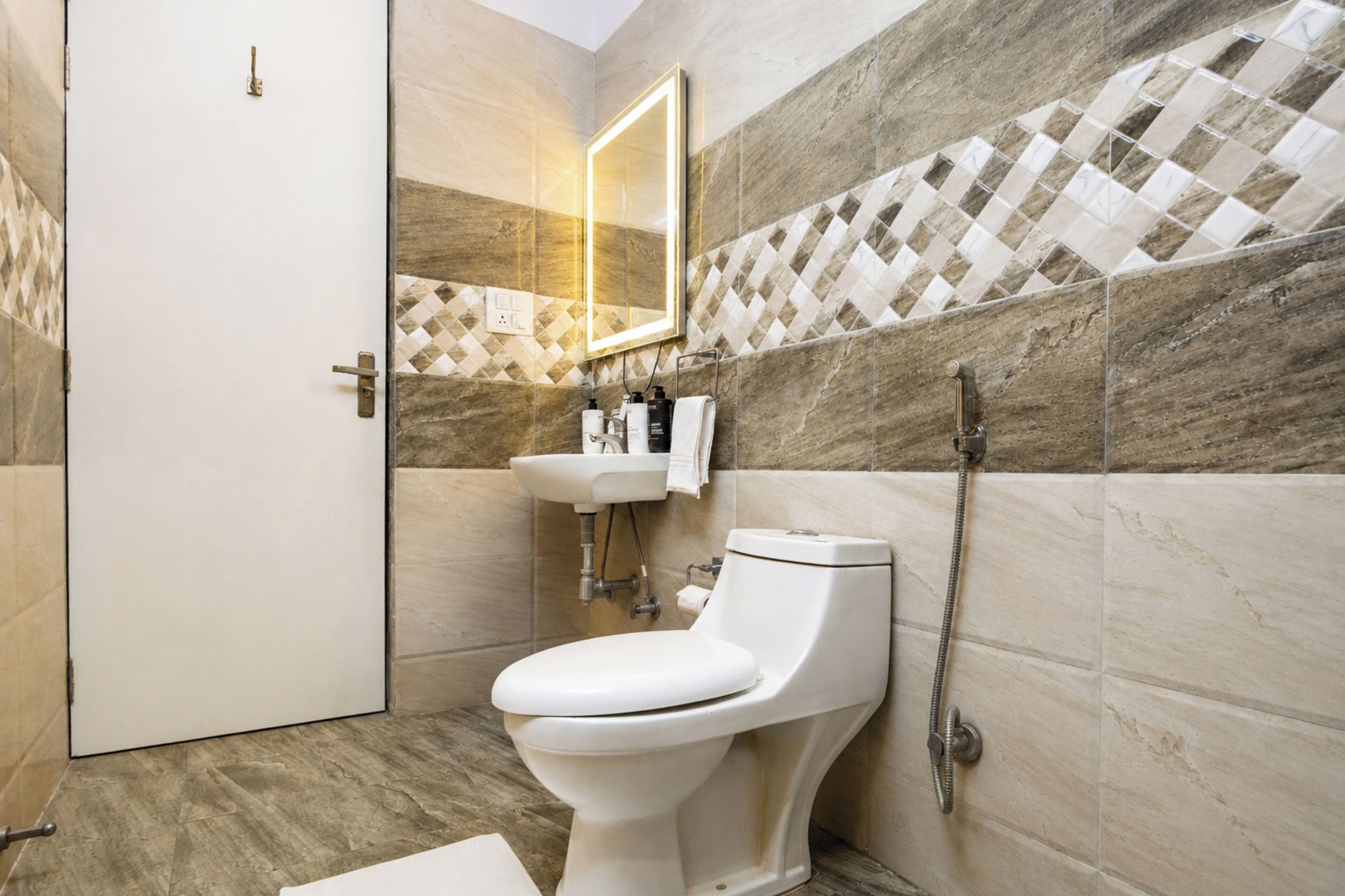 A modern bathroom with a toilet, sink, and shower.