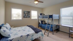 A bedroom with a bunk bed, a desk, and a ceiling fan. - Waterfront Family Home w/ Views in Carrabelle (Carrabelle)