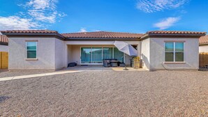A house with a patio area, a sliding glass door entrance, and a barbecue grill. - 'Rapt Expression' Queen Creek Home w/ Patio! (Queen Creek)