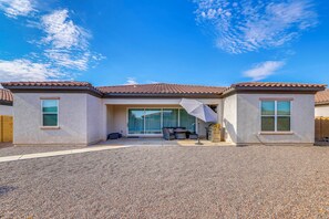 A house with a patio area, a sliding glass door entrance, and a barbecue grill. - 'Rapt Expression' Queen Creek Home w/ Patio! (Queen Creek)