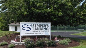 A sign for Striper's Landing Condominiums, indicating it is a private community.