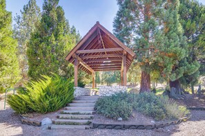 A wooden gazebo with a stone bench, surrounded by trees and a gravel path. - Hike, Swim & Relax: Pine Mountain Club Escape! (Frazier Park)