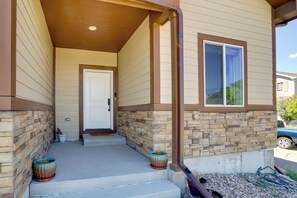 A house with a stone foundation, a front door, and a window. - Updated Family Home w/ Patio in Brighton (Brighton)