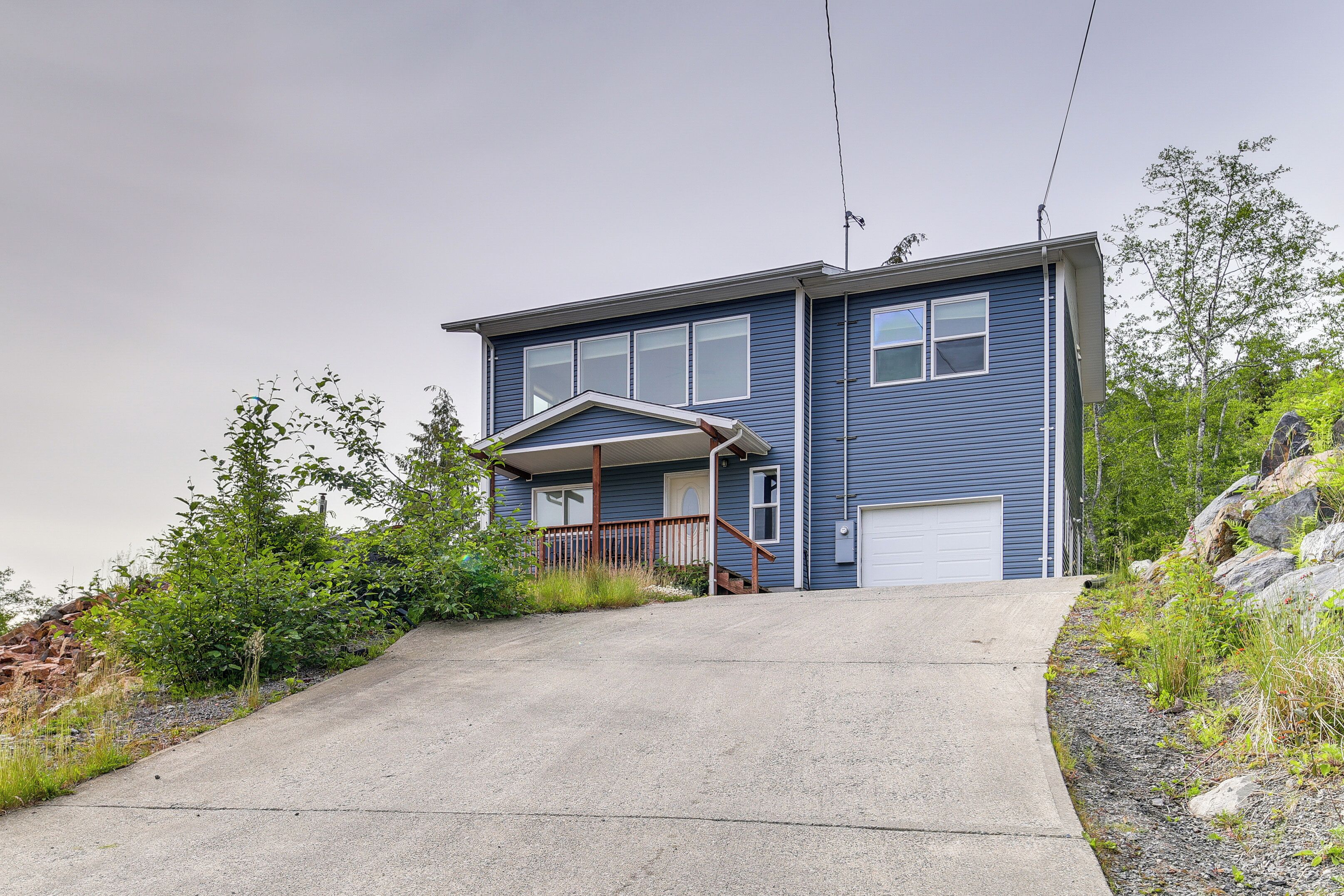 A two-story house with a front porch and a garage.