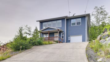 A two-story house with a front porch and a garage.